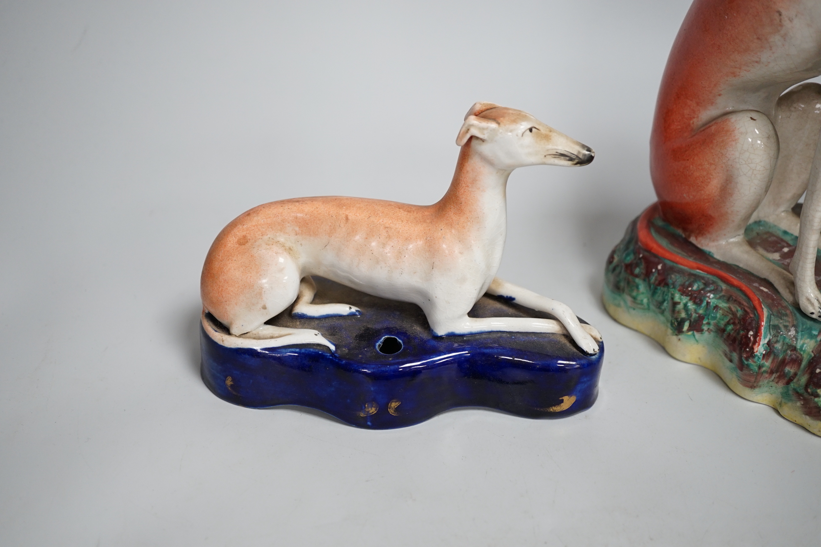Four Staffordshire dogs including greyhounds and a spaniel, the largest 29cm high